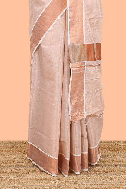Cream kerala tissue plain saree highlighted by a classic copper jari border