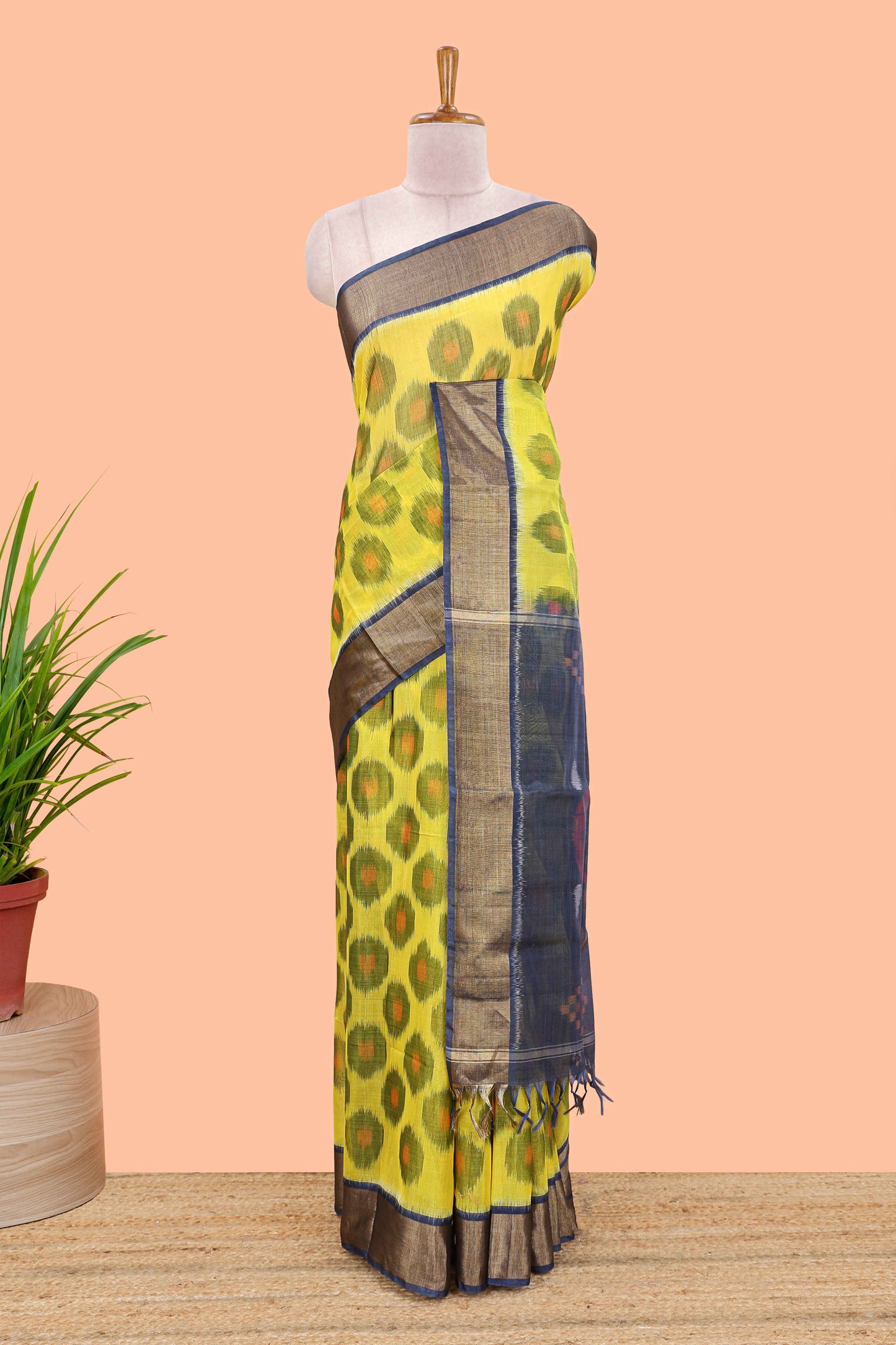 Yellow ikkat cotton saree featuring traditional pochampally motifs and zari border