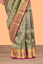 Green zari designed floral motifs Kanchipuram silk saree with contrast zari border and zari work pallu comes with contrast blouse