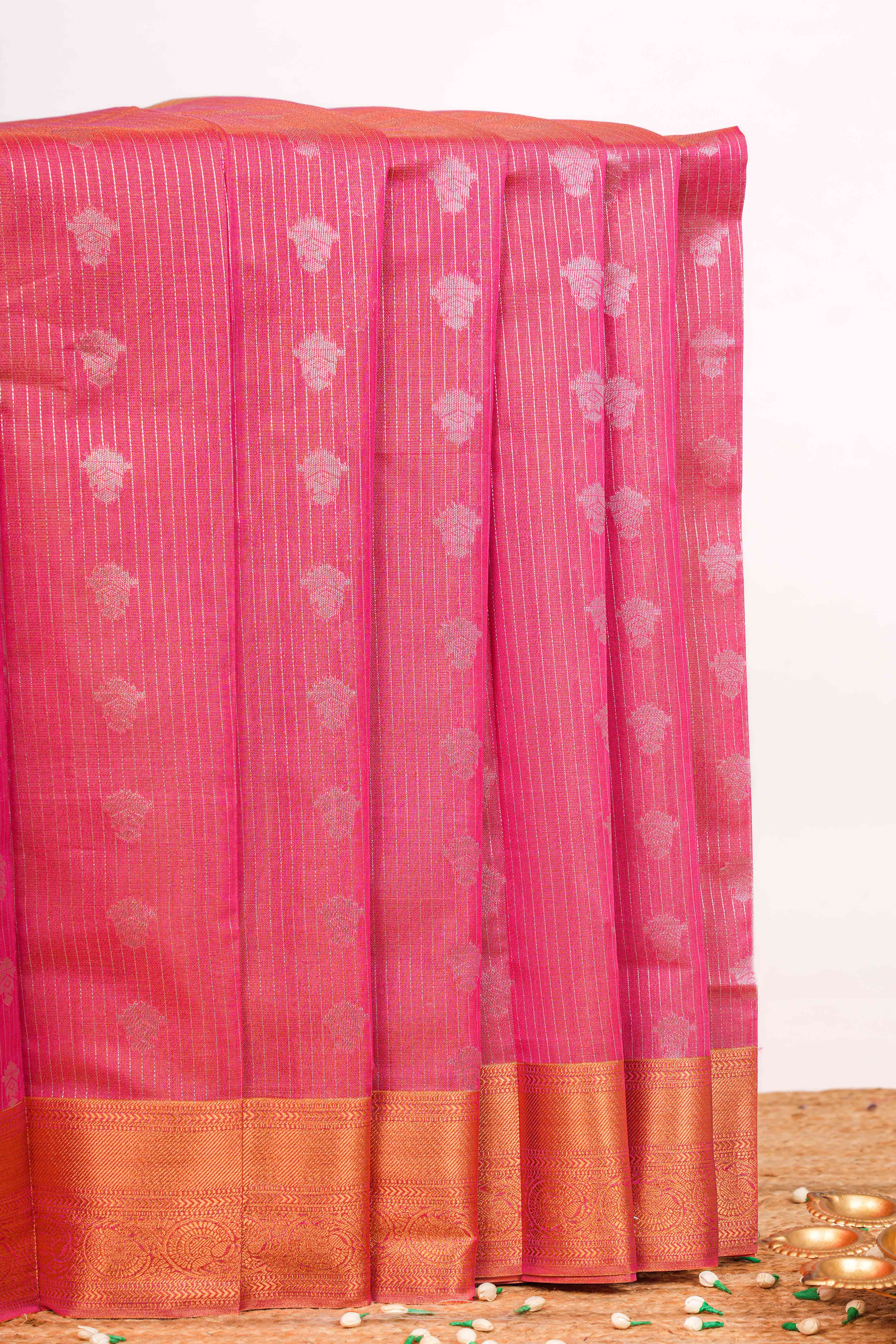 Kota with woven silver zari floral motifs arranged vertically across the body 
