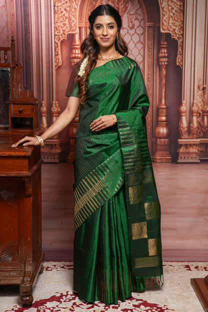 Borderless green parambariya pattu saree with zari stripes and matching checked zari pallu