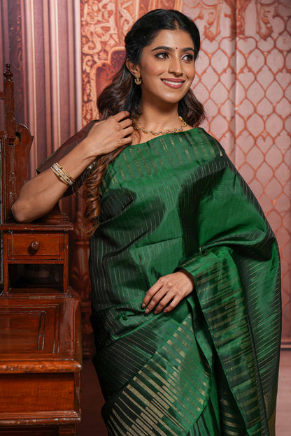 Borderless green parambariya pattu saree with zari stripes and matching checked zari pallu