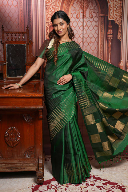 Borderless green parambariya pattu saree with zari stripes and matching checked zari pallu
