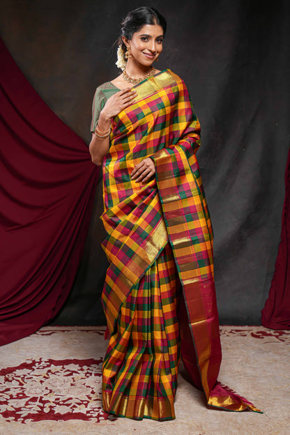 Multi color checked parambariya pattu saree with self zari border and contrast striped pallu