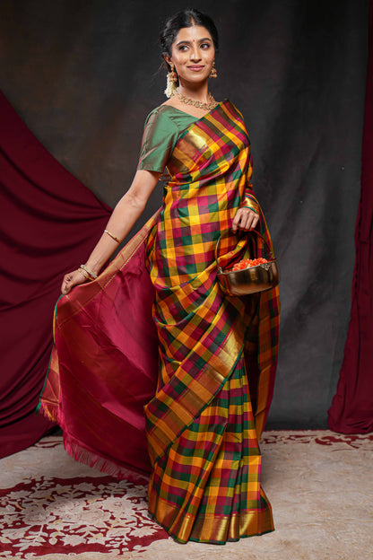 Multi color checked parambariya pattu saree with self zari border and contrast striped pallu