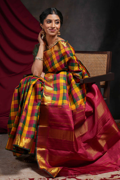 Multi color checked parambariya pattu saree with self zari border and contrast striped pallu