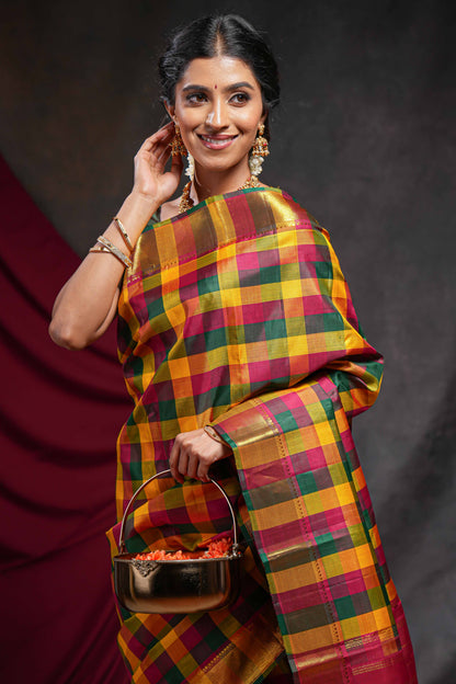Multi color checked parambariya pattu saree with self zari border and contrast striped pallu