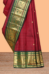 Maroon zari motifs parambariya pattu saree with contrast zari border and blouse