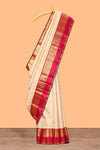 Beige zari motifs parambariya pattu saree with contrast zari border and blouse