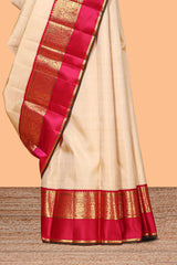 Beige zari motifs parambariya pattu saree with contrast zari border and blouse