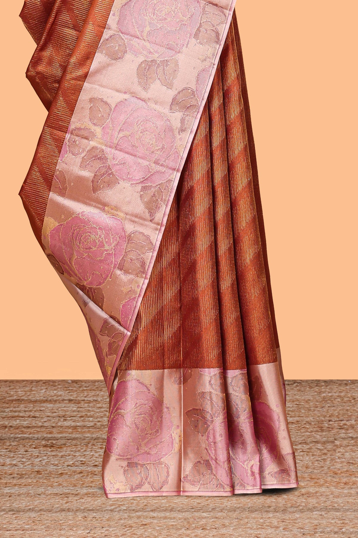 Rust orange geometric design parambariya pattu saree with contrast floral border and motifs blouse