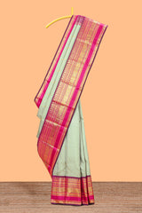 Mint green gold zari butta designed parambariya pattu saree with contrast golden zari border and contrasting pallu beautiful zari design