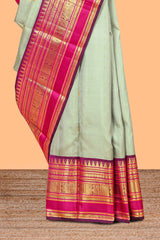 Mint green gold zari butta designed parambariya pattu saree with contrast golden zari border and contrasting pallu beautiful zari design