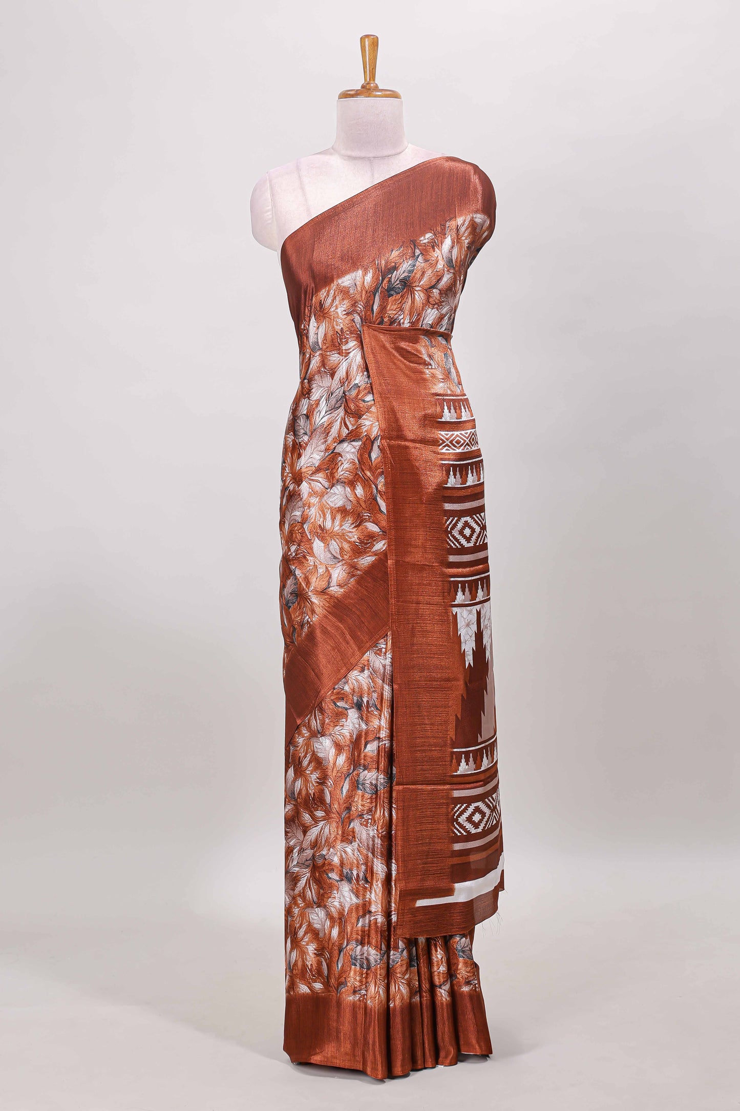 Rust red all over leaf print crepe turkey saree with self border and ikkat style pallu
