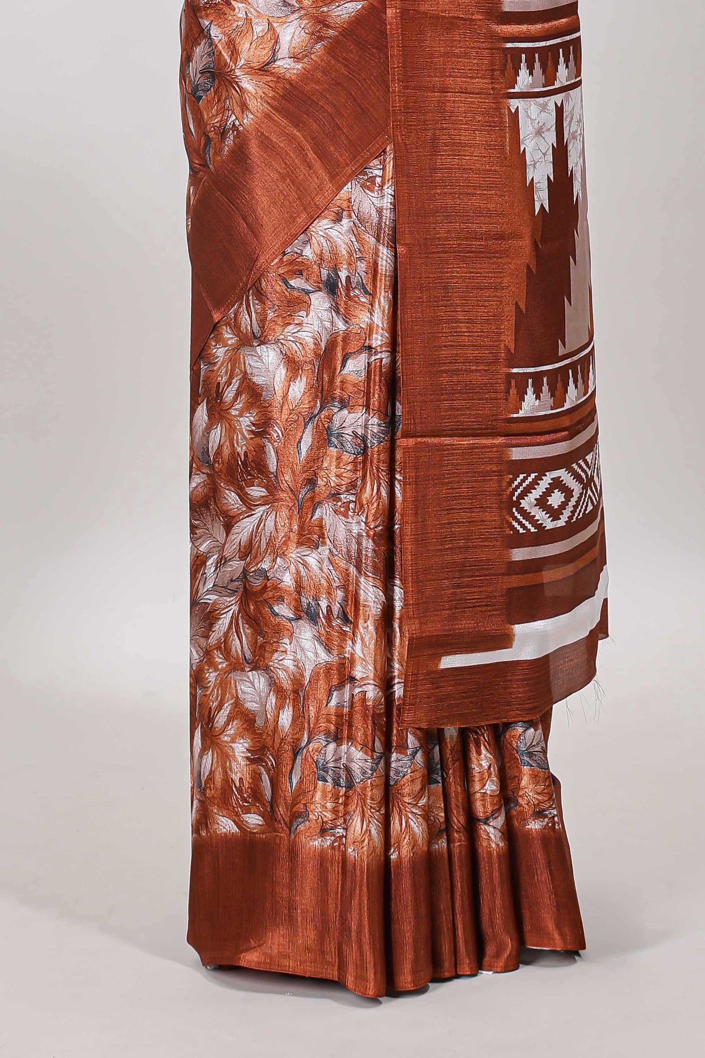Rust red all over leaf print crepe turkey saree with self border and ikkat style pallu