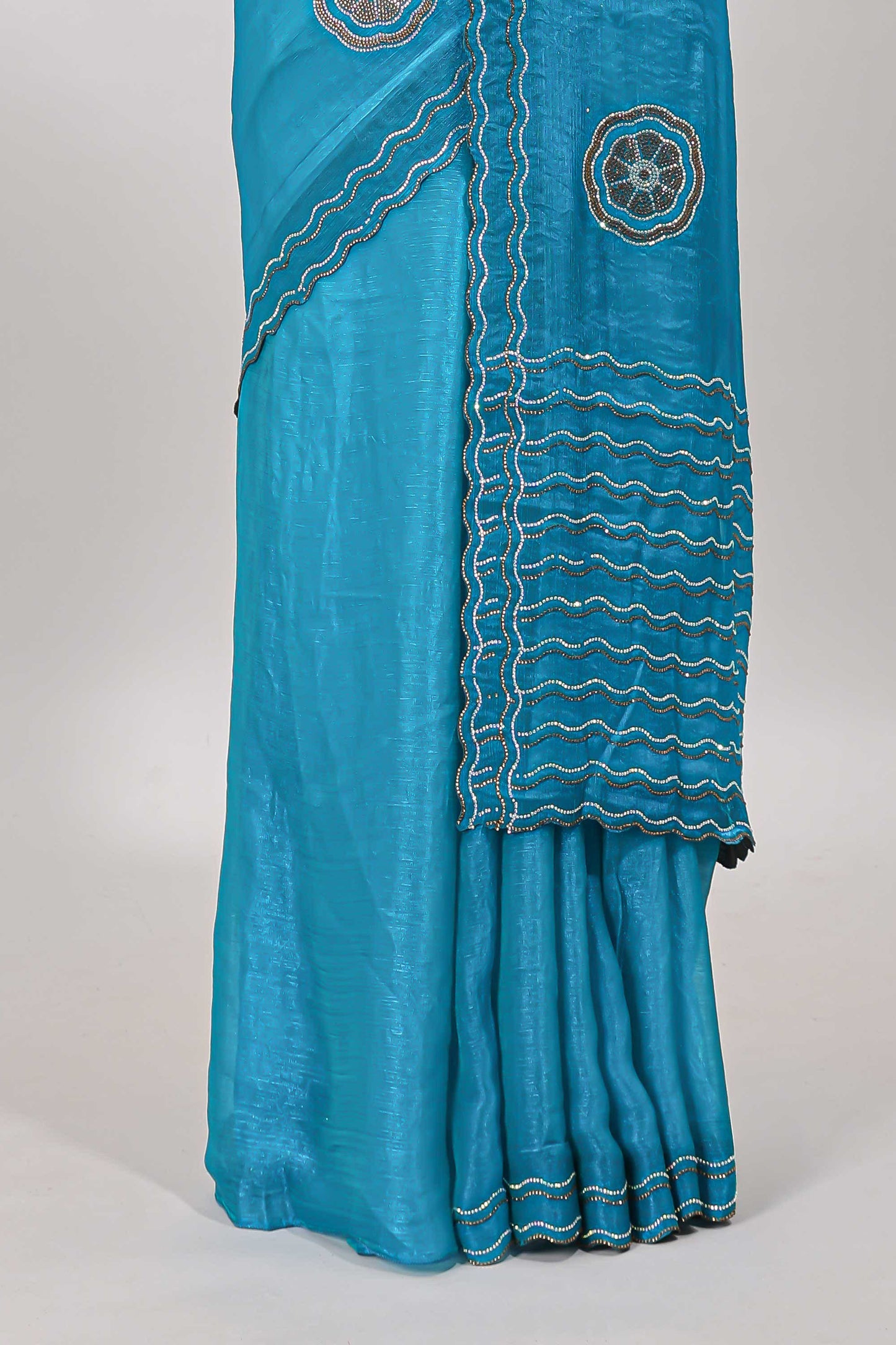Blue floral stone work motifs semi chiffon saree with self scallop border and matching blouse