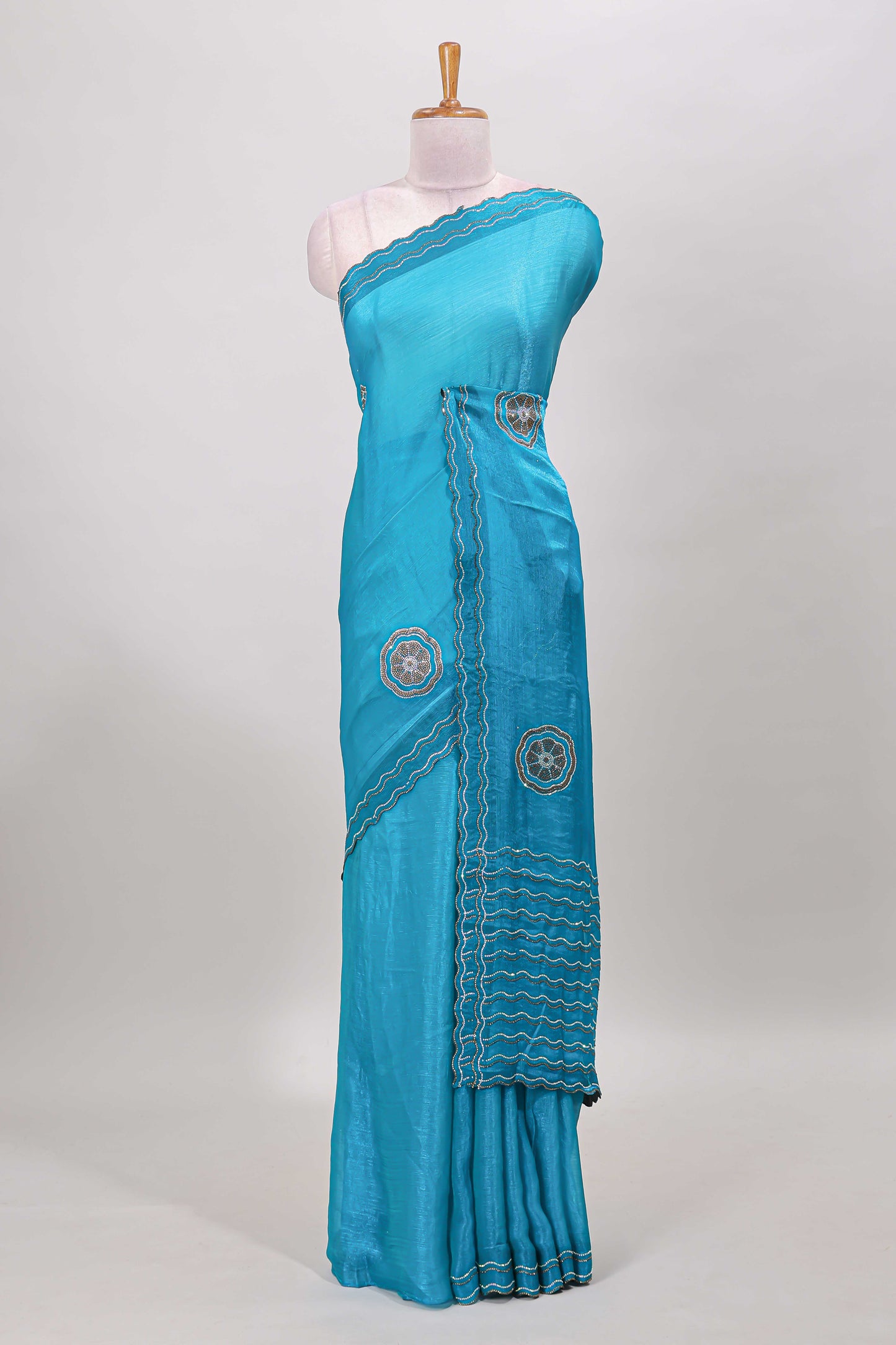 Blue floral stone work motifs semi chiffon saree with self scallop border and matching blouse