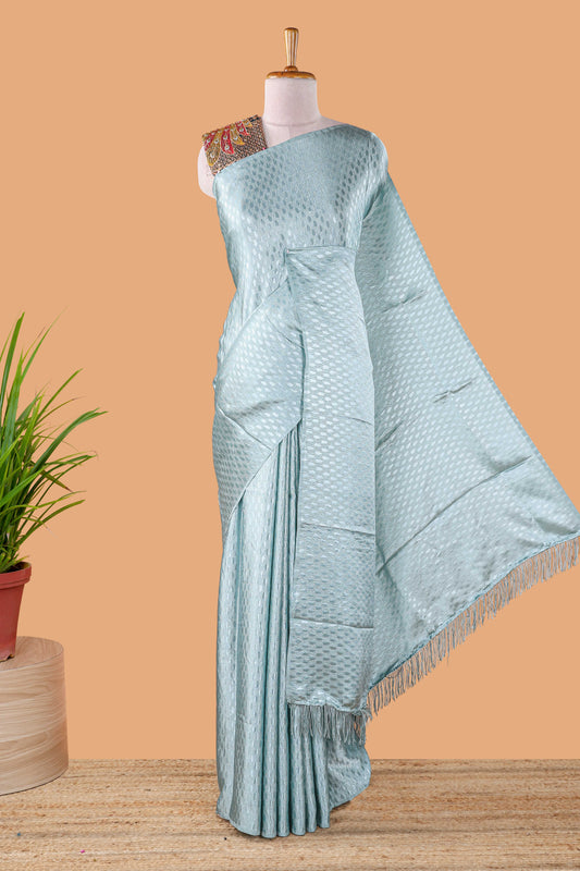 Borderless blue Jacquard Satin Georgette Crush Saree paired with a contrast blouse featuring exquisite peacock embroidery