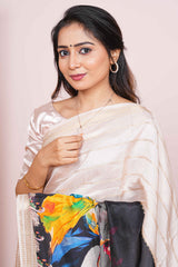 Woman wearing a white saree with a colorful blouse 