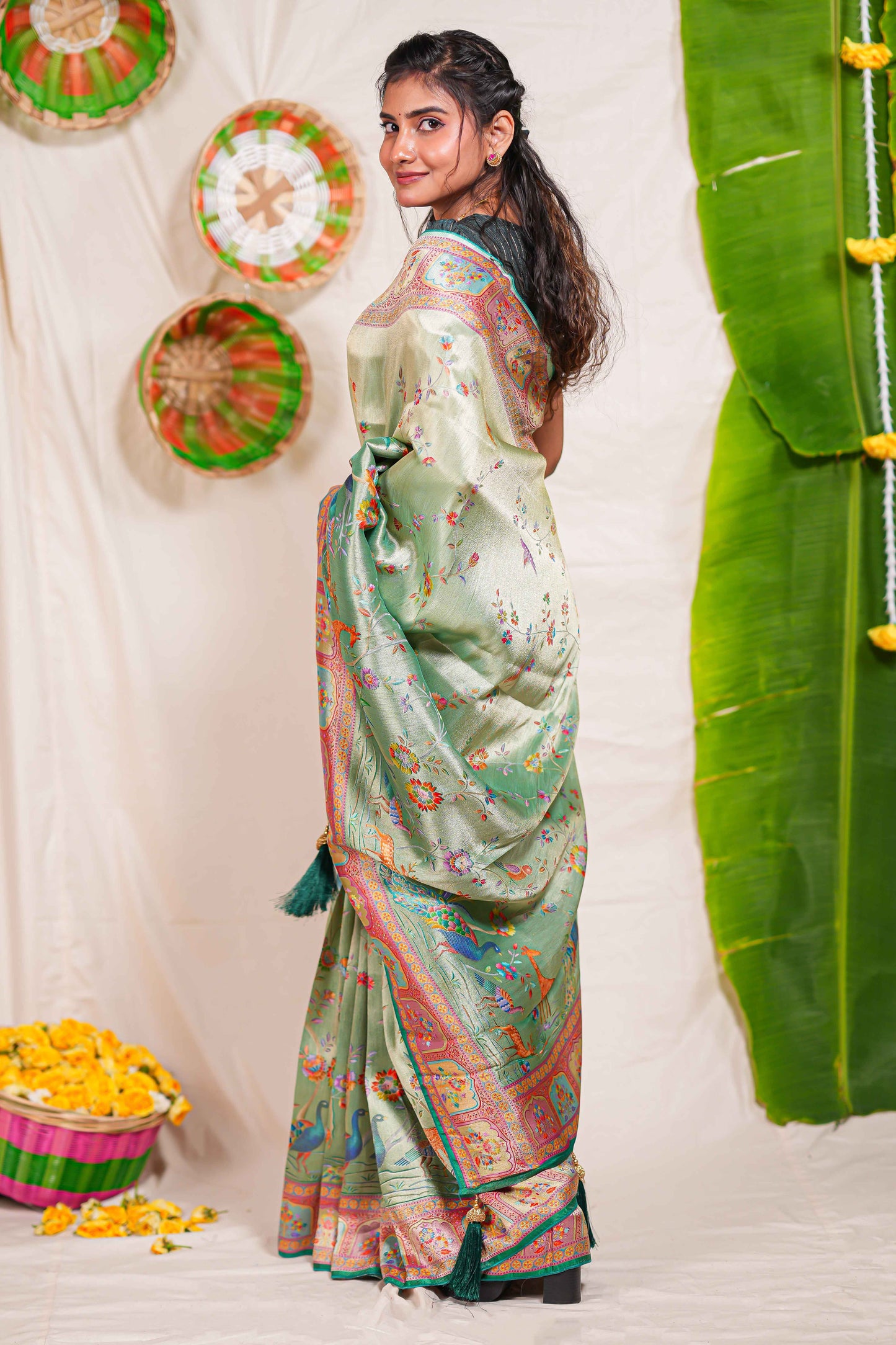 Pastel green floral and animal themed banarasi silk saree with contrast border matching blouse